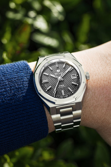 F77 Grey MK2 automatic watch on wrist with stainless steel integrated bracelet and tressed grey dial