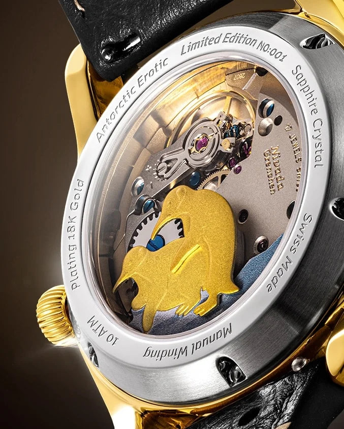 Macro of the two gold-plated penguins on the movement, seen through the caseback