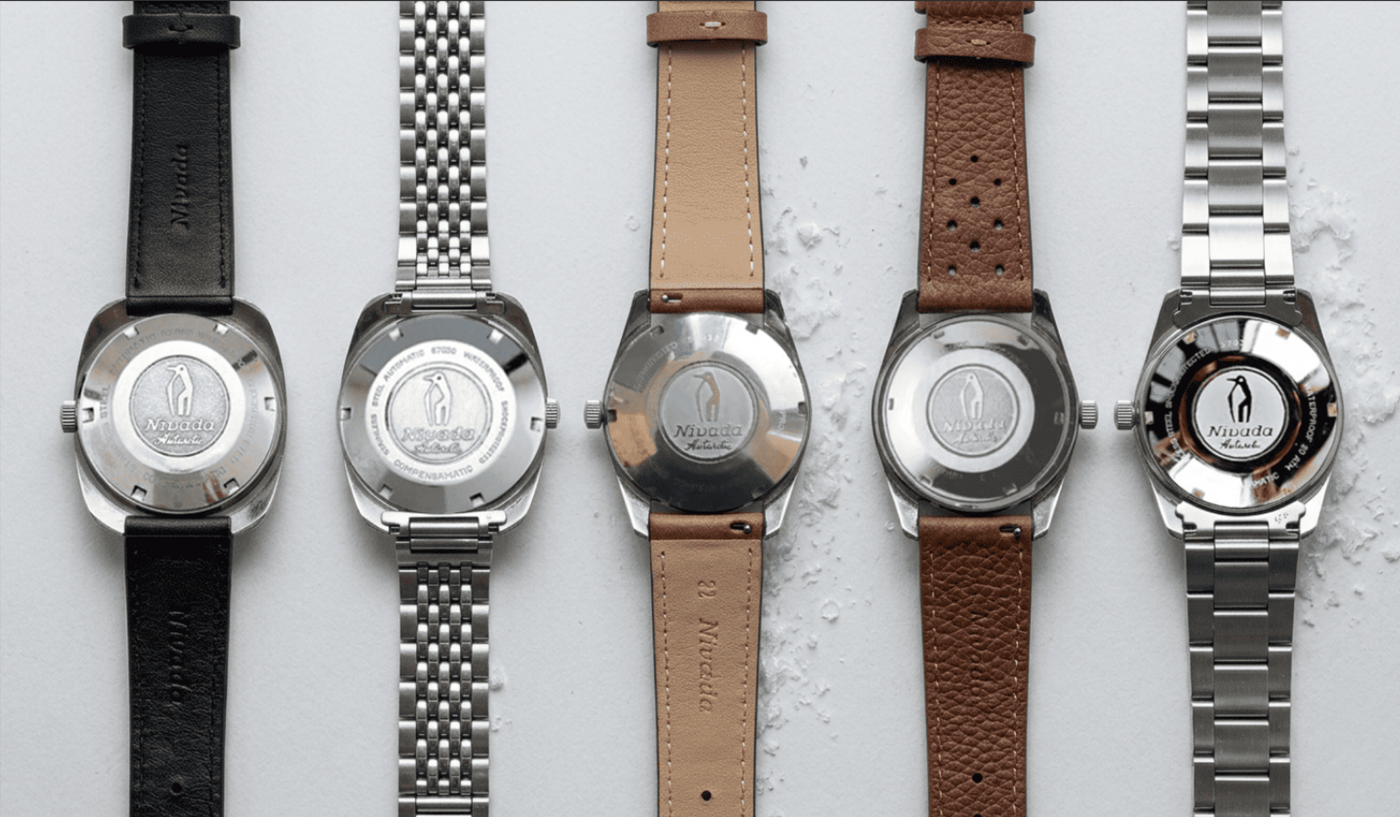 Vintage Swiss watch caseback collection with penguin engraving, mid-20th-century polar expedition design 