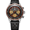 A Nivello Cosmopolitan chronograph watch with a black textured leather strap, a silver stainless steel case, a black dial with beige subdials, and a distinctive orange and white rotating bezel.