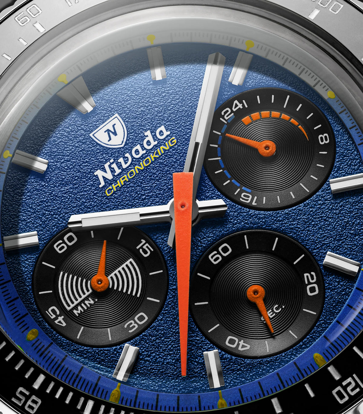 Macro of the Nivada Grenchen Chronoking Mecaquartz Racing Blue dial with orange hand and three black subdials