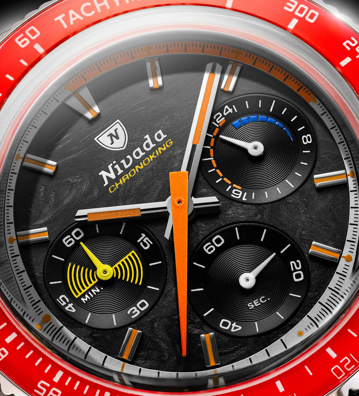 Macro of Nivada Grenchen Chronoking Racing dial with orange hands, three subdials and red tachymetre bezel