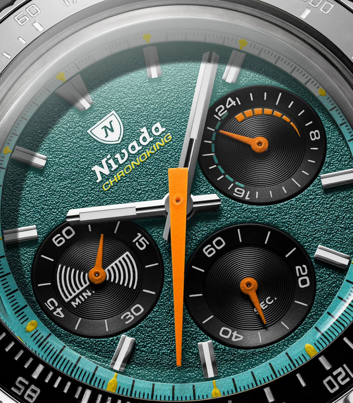 Macro of the Nivada Grenchen Chronoking Mecaquartz Racing Green dial with orange hand and black subdials